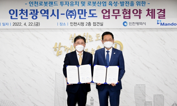 박남춘 인천광역시장이 22일 시청 접견실에서 열린 인천로봇랜드 투자유치 및 로봇산업 육성·발전을 위한 '인천광역시-(주)만도 업무협약 체결식'에서 (주)만도 조성현 대표이사와 협약을 체결한 뒤 기념촬영을 하고 있다.