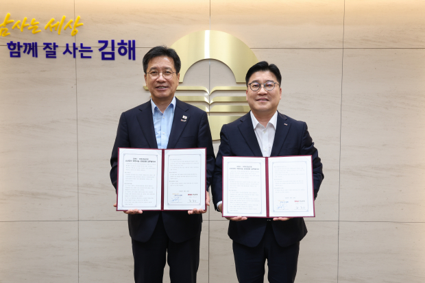 정영두 김해시장(왼쪽)과 BNK경남은행 관계자가 지난 19일 ‘소상공인 희망나눔 상생금융 업무협약’을 체결한 뒤 협약서를 들어 보이고 있다./사진=김해시